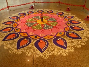 An elaborate Rangoli or Kolam made from rice colored with food coloring.